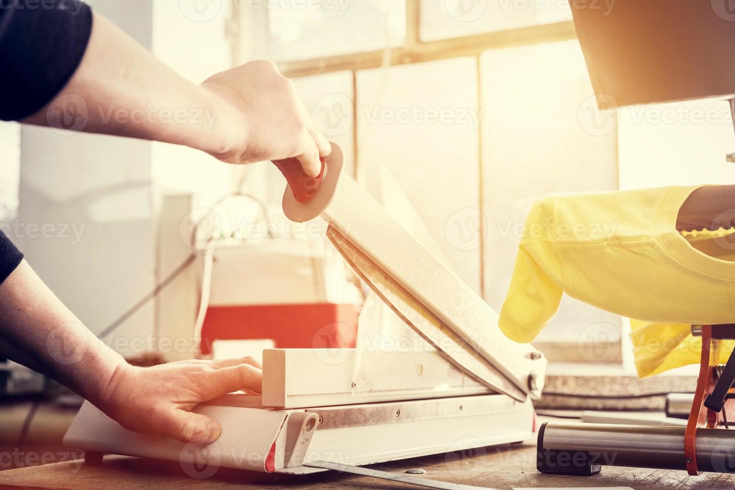 Man using manual paper cutter. Manufacture photo