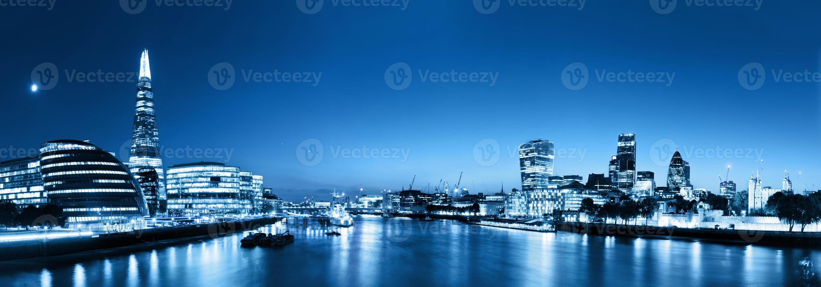 London skyline panorama at night, England the UK. River Thames, the Shard, City Hall. photo