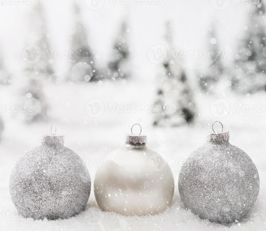 Christmas glass balls in winter miniature forest scenery with snow. photo