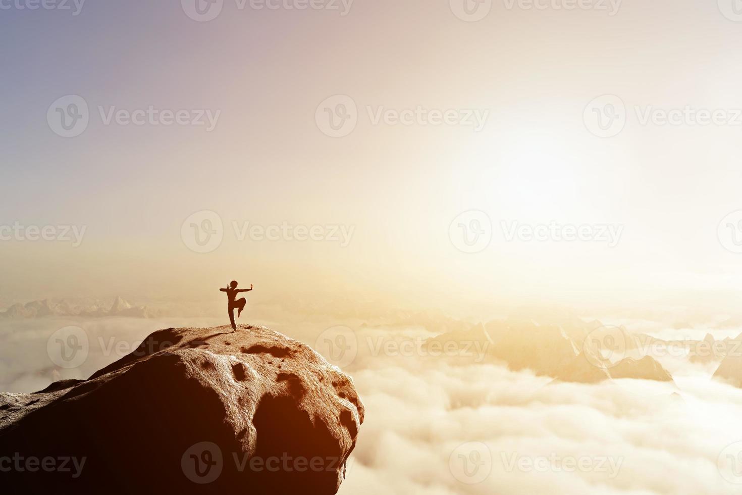 Asian man, fighter practices martial arts in high mountains above clouds. photo