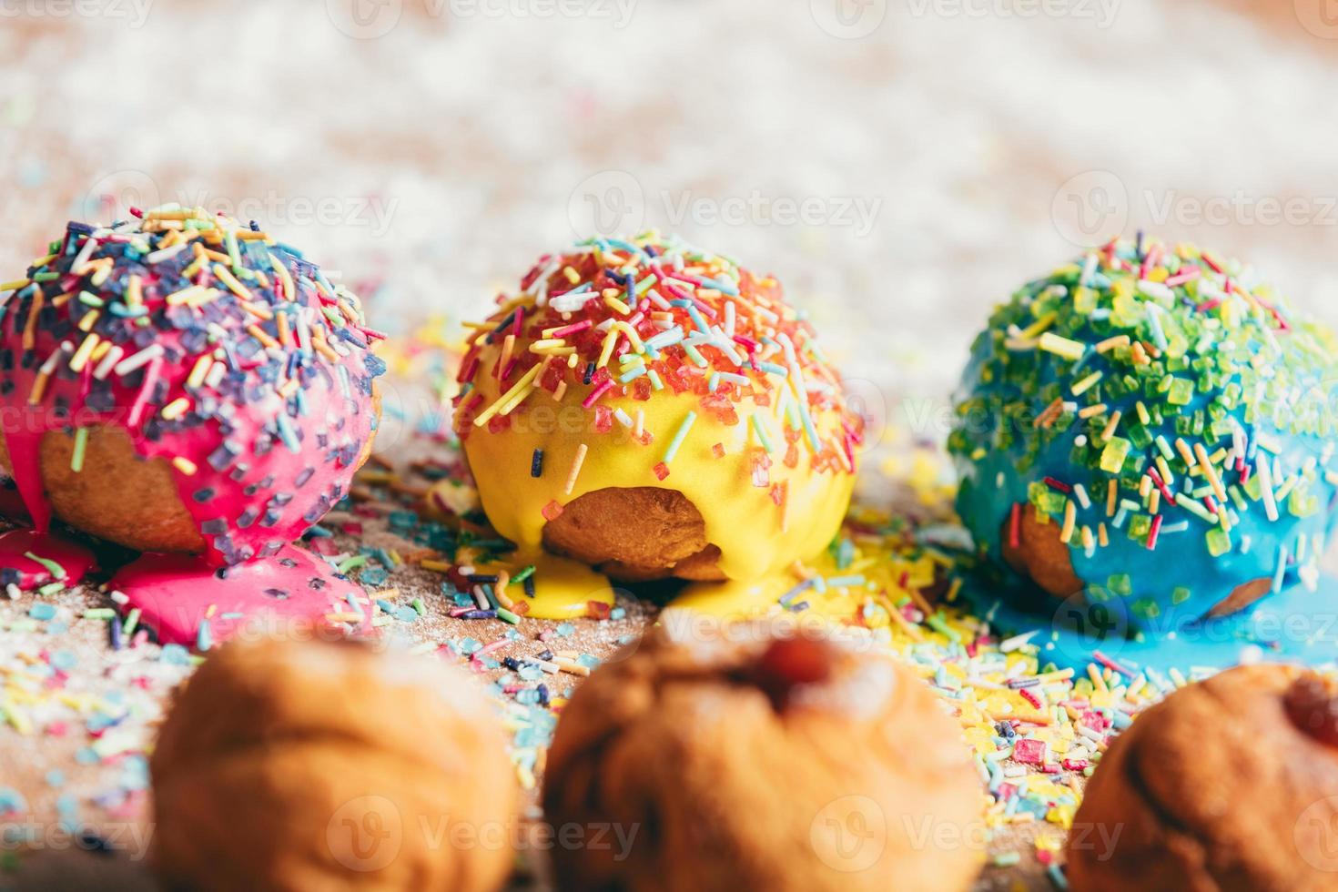 Three donuts laying on a messy kitchen counter photo