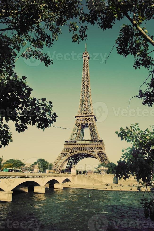 Eiffel Tower and bridge on Seine river in Paris, France. Vintage photo