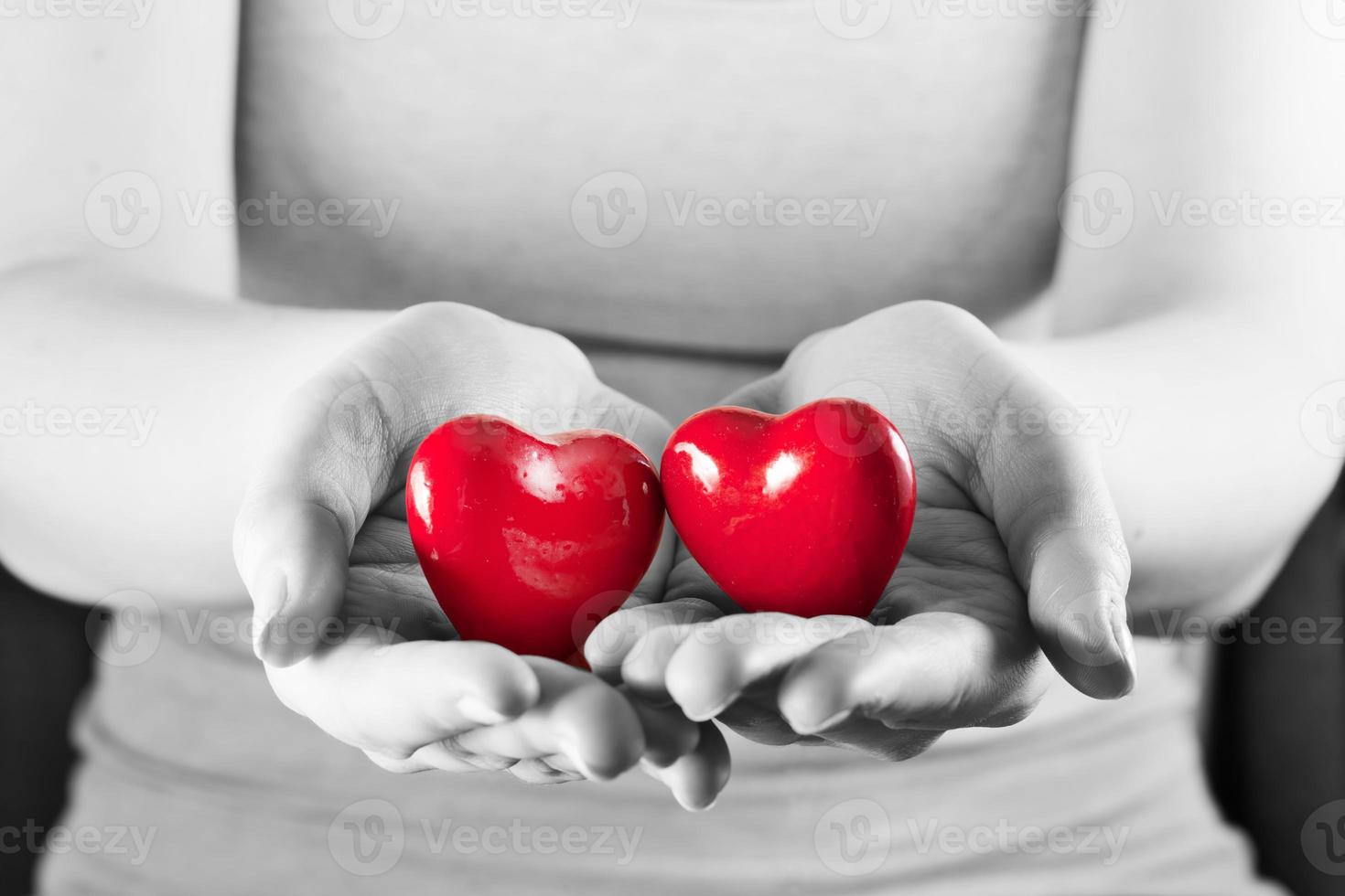 Two hearts in woman hands. Love, care, health, protection. photo