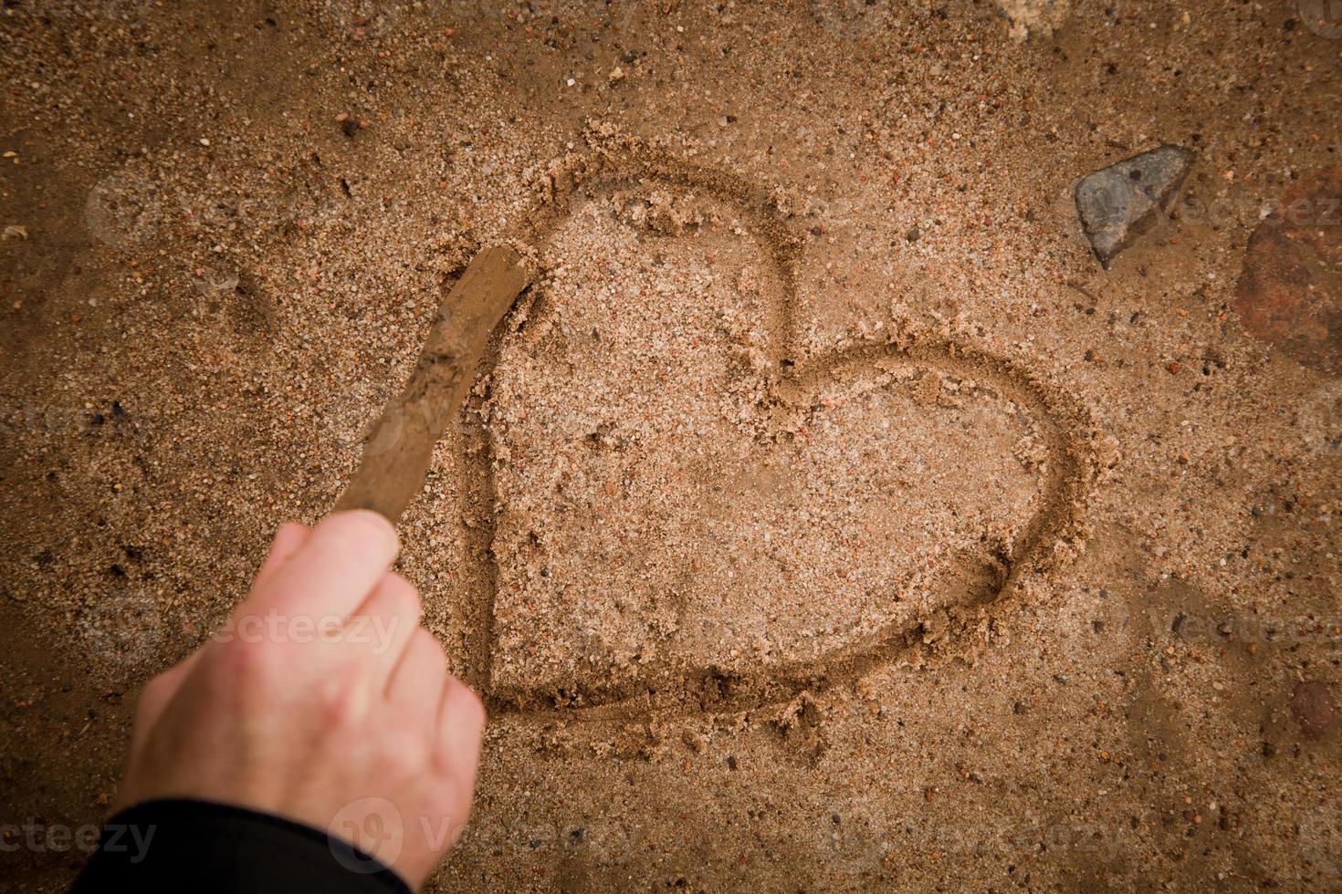 Drawing heart on ground photo