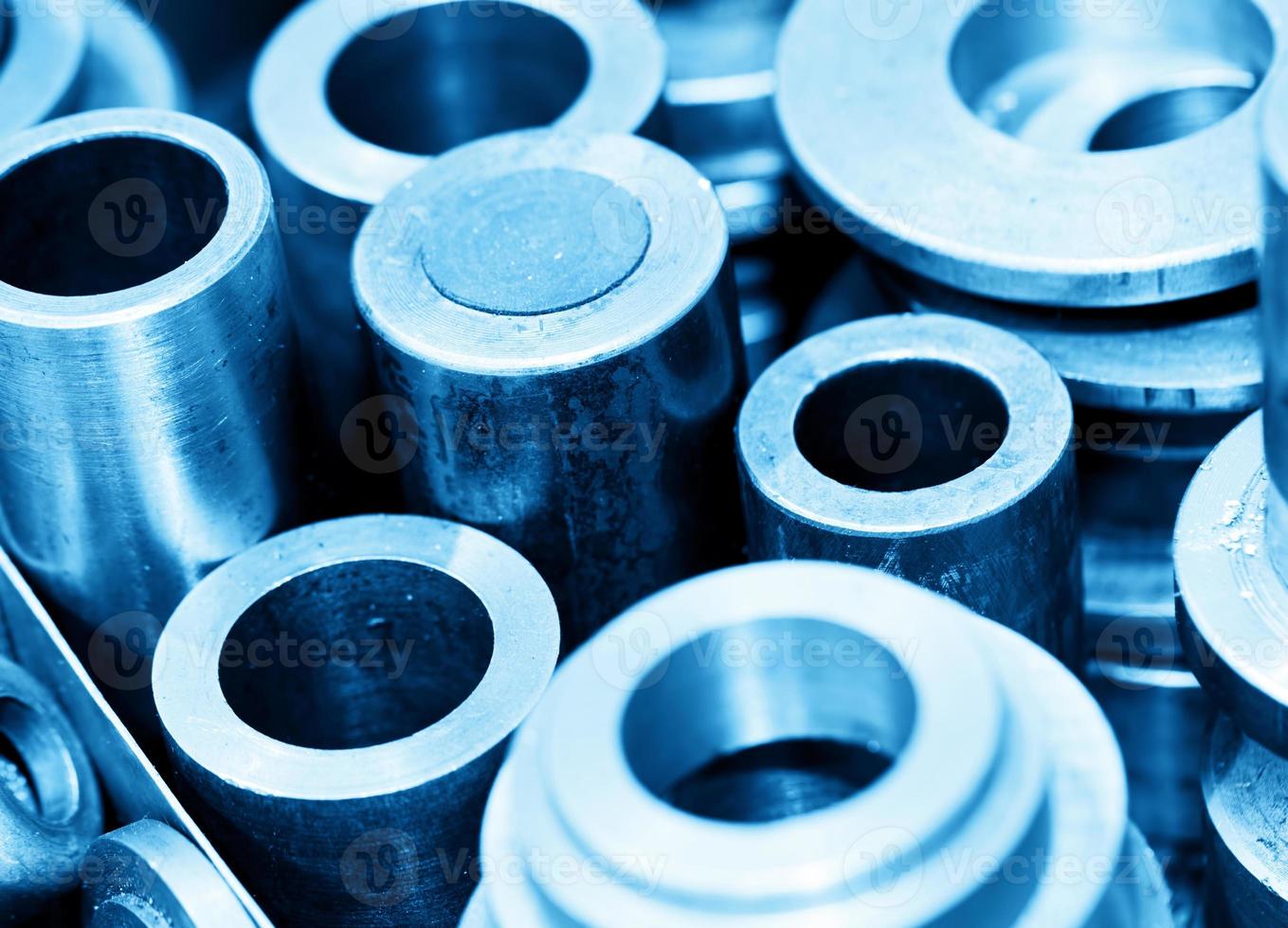Steel cylinders, pistons and tools in workshop. Industry theme. photo