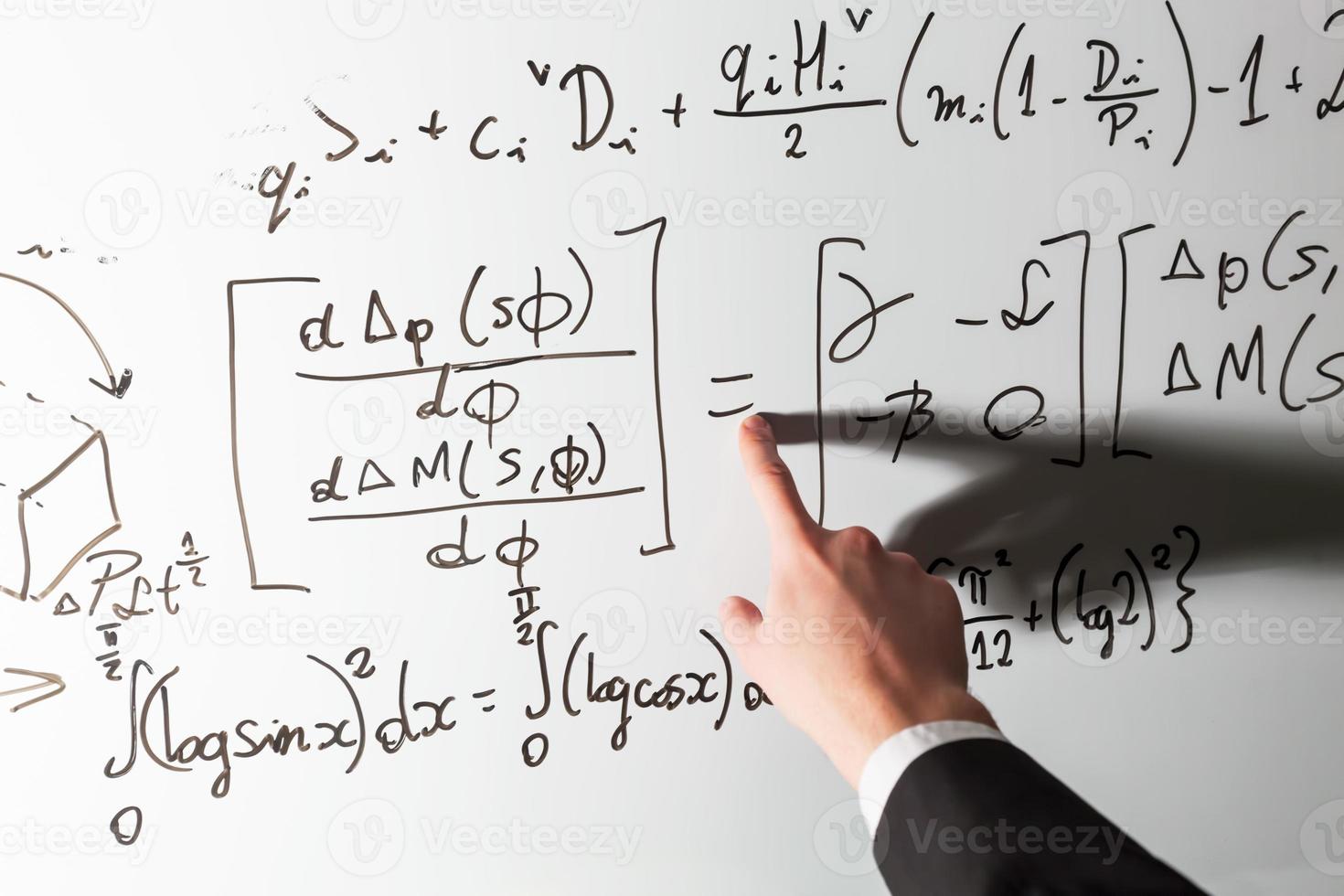 Teacher pointing finger on equality math symbol on whiteboard. Mathematics and science photo