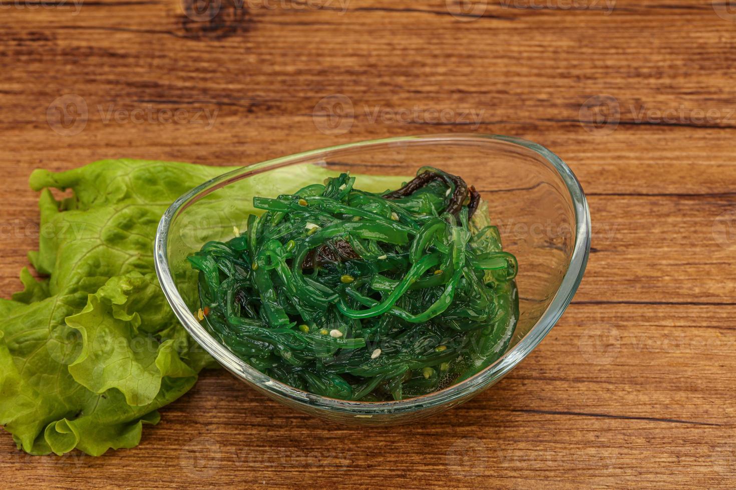 Green Chuka Seaweed Salad Isolated on White Background Top View. Wakame Sea Kelp Salat photo