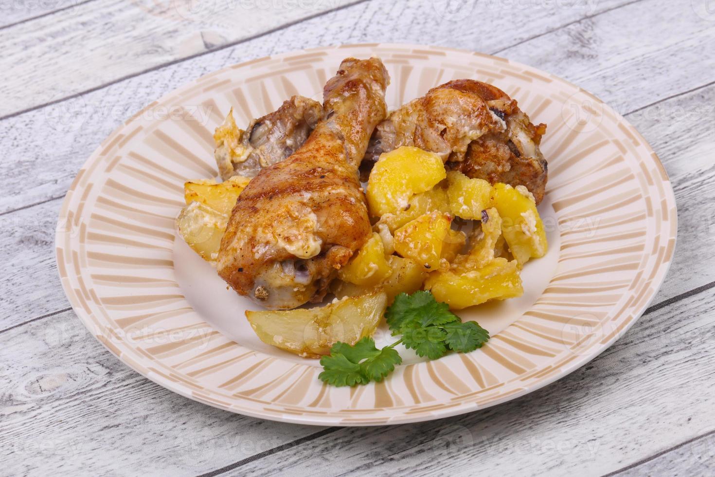 Roasted chicken legs with potato photo