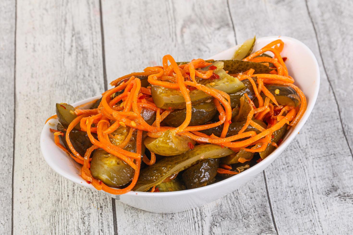 Pickled cucumbers with carrot and herbs photo