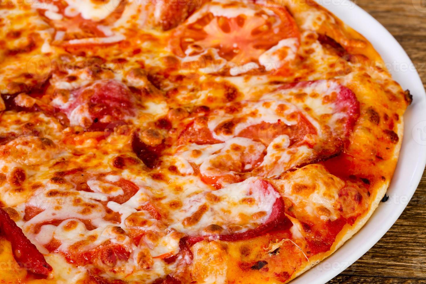 Pepperoni pizza with sausages photo