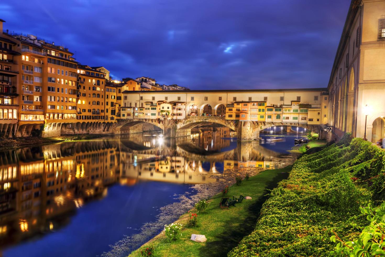Florence, Italy, 2022 - Ponte Vecchio bridge in Florence, Italy. Arno River at night photo