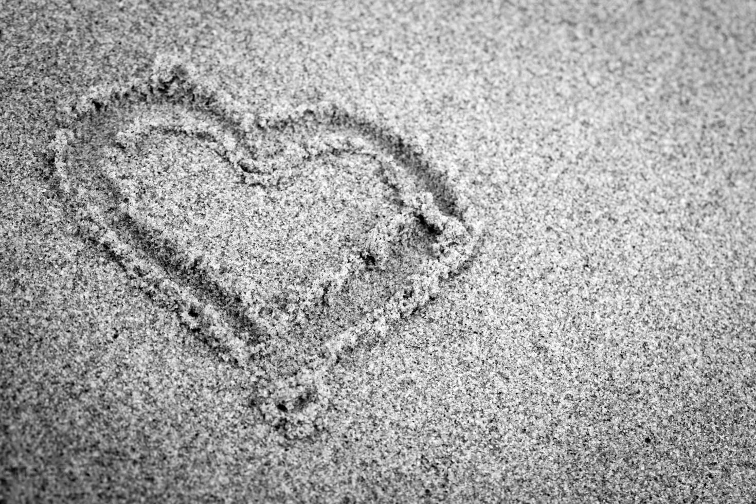 Heart shape on sand. Romantic, black and white photo