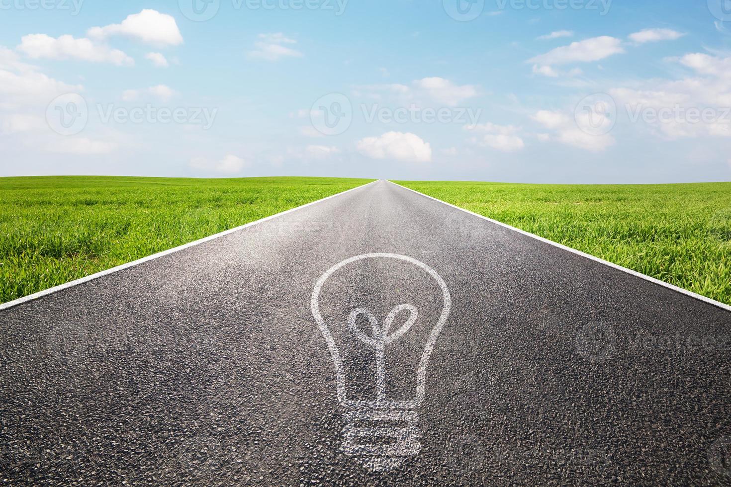 Light bulb symbol on long empty straight road. Environment, idea photo