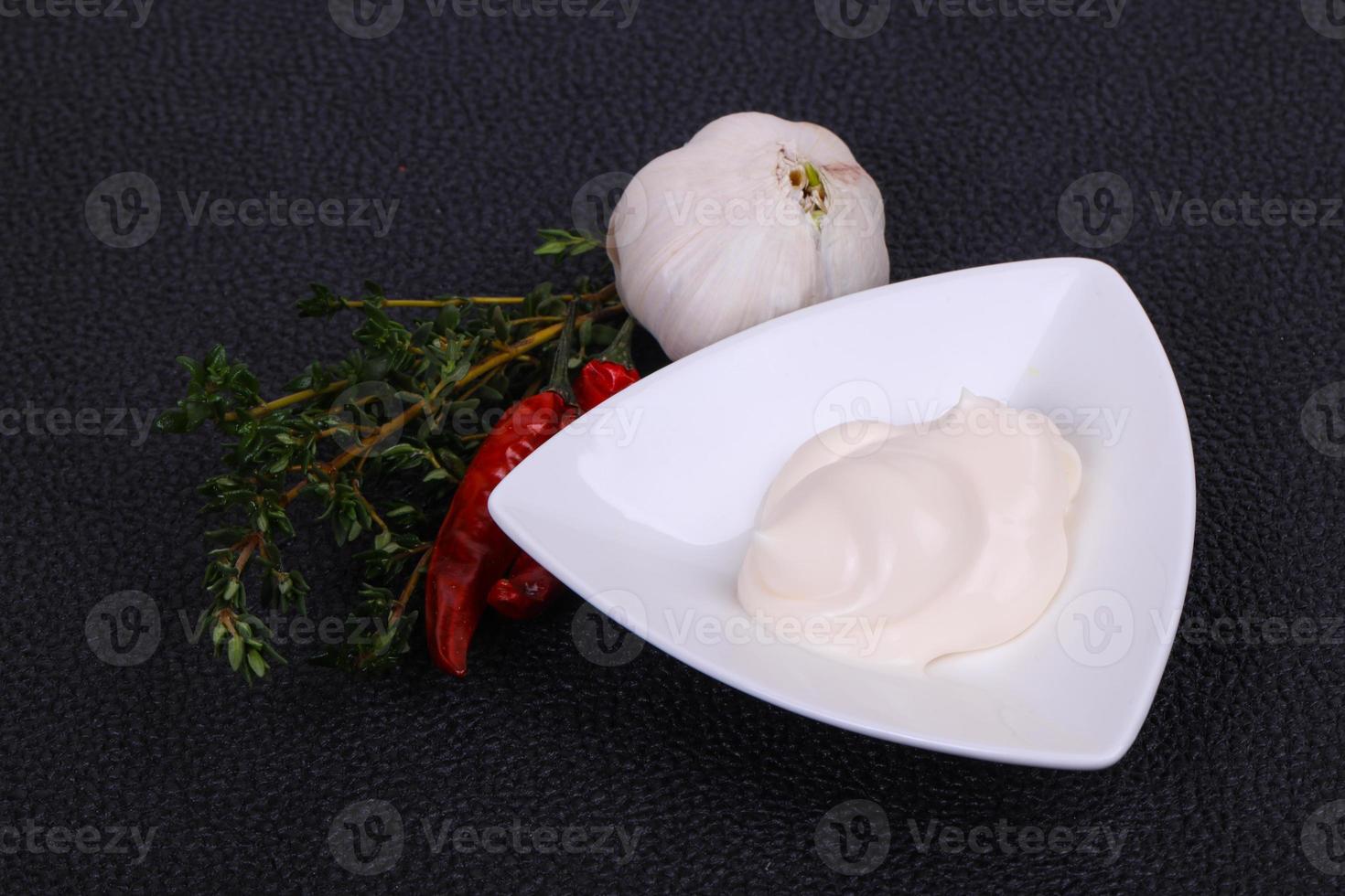 Mayonnaise sauce in the white bowl served thyme and garlic photo