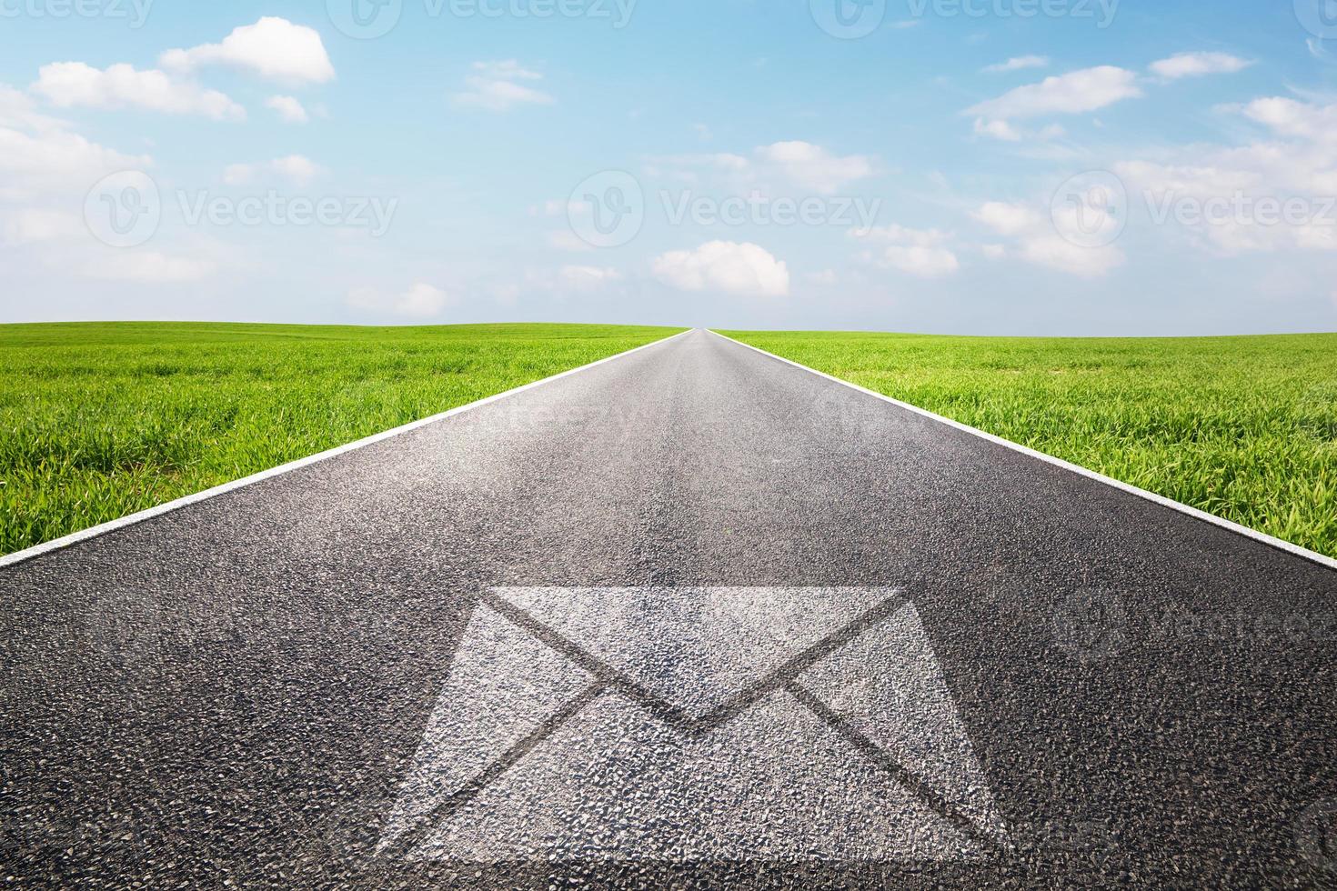 Mail, message symbol on long straight road, highway. photo