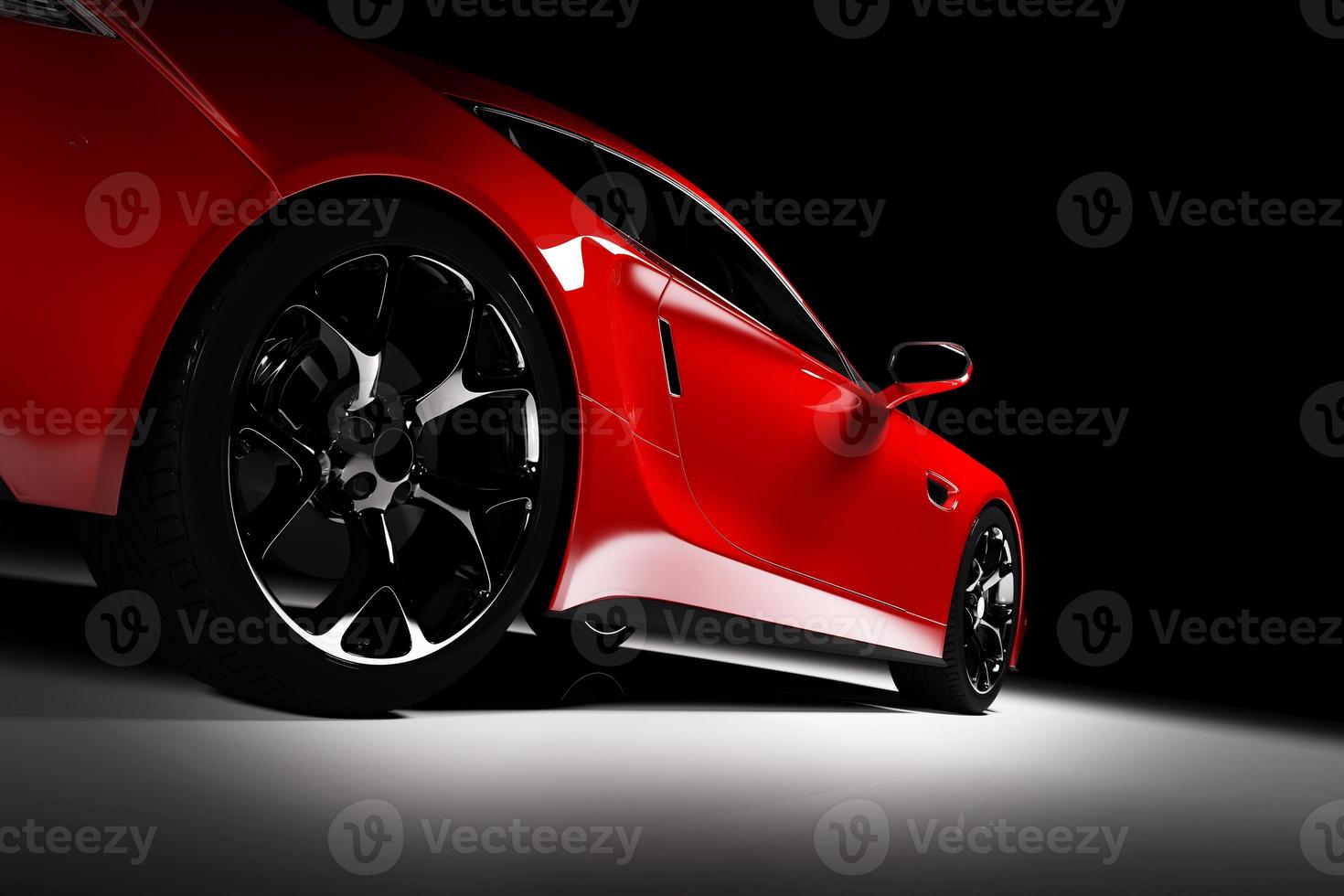 Modern red sports car in a spotlight on a black background. photo