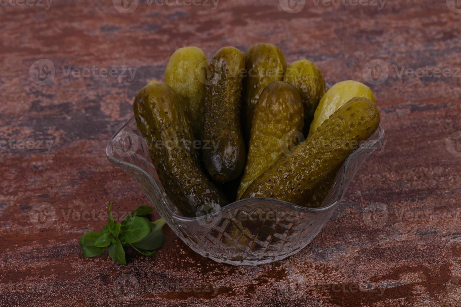 Pickled cucumbers heap in the bowl photo
