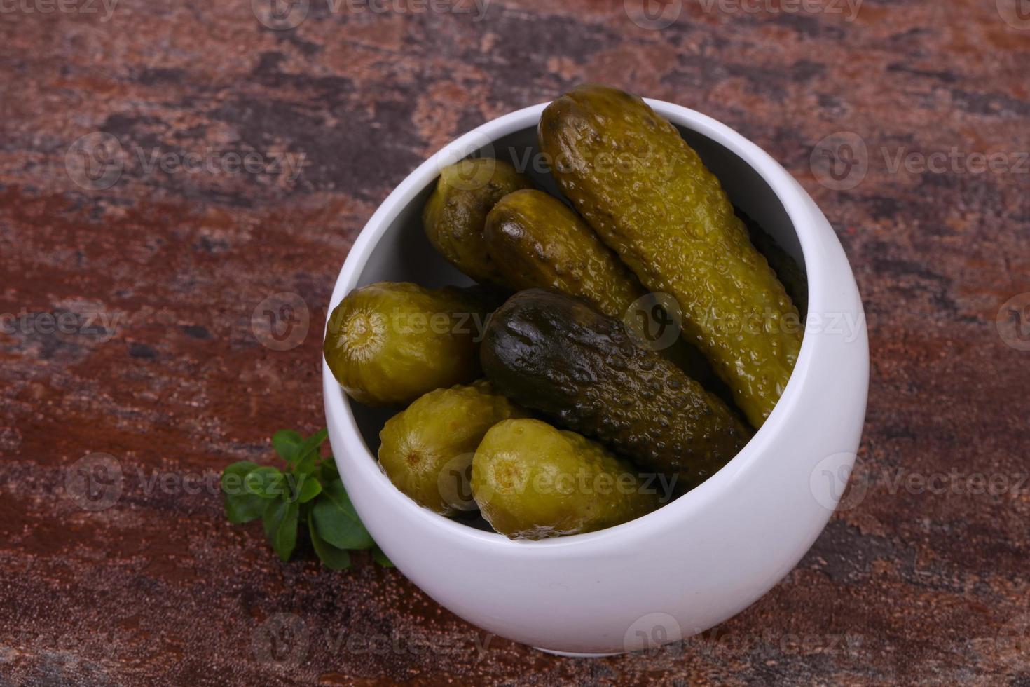 Pickled cucumbers heap in the bowl photo