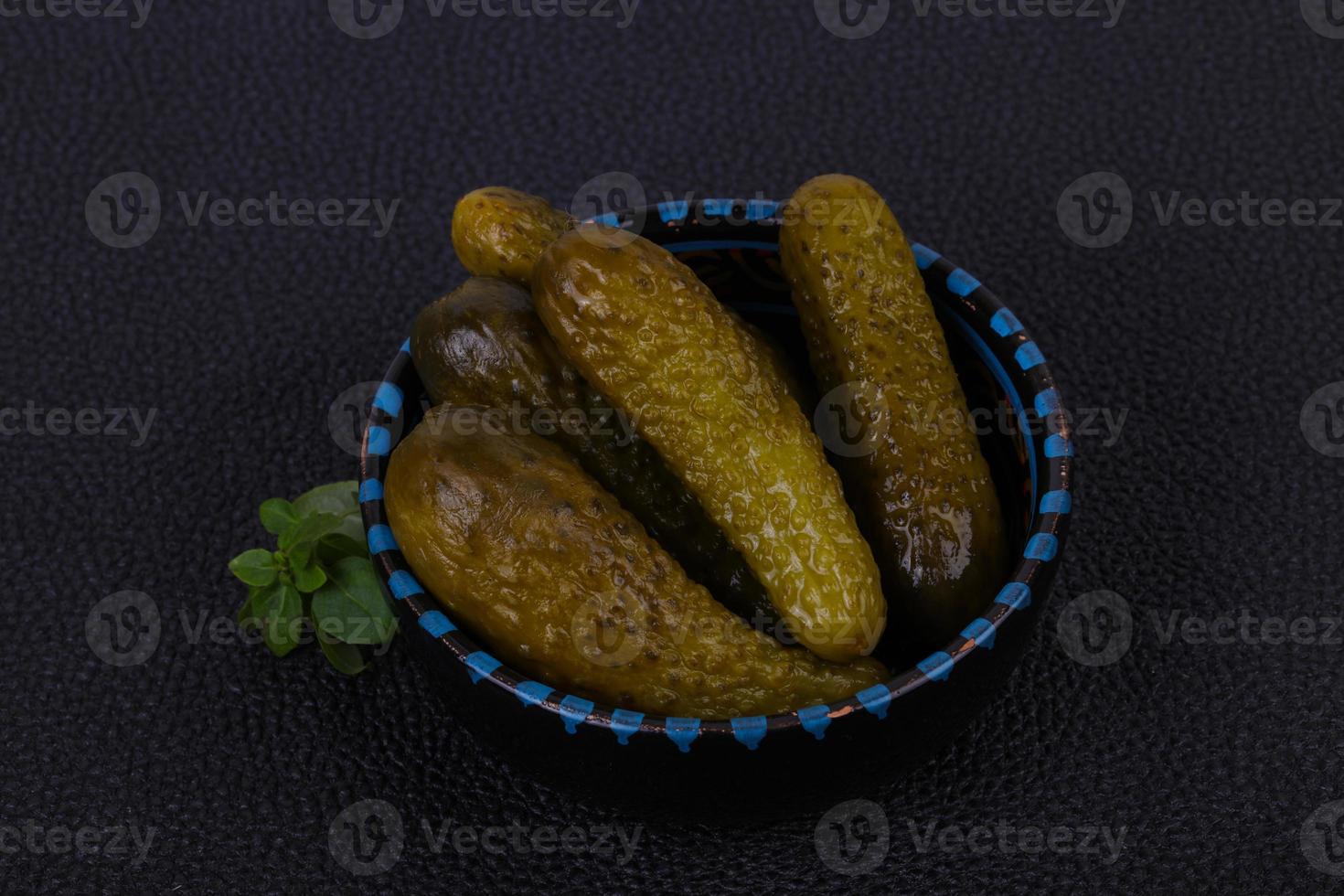 Pickled cucumbers heap in the bowl photo