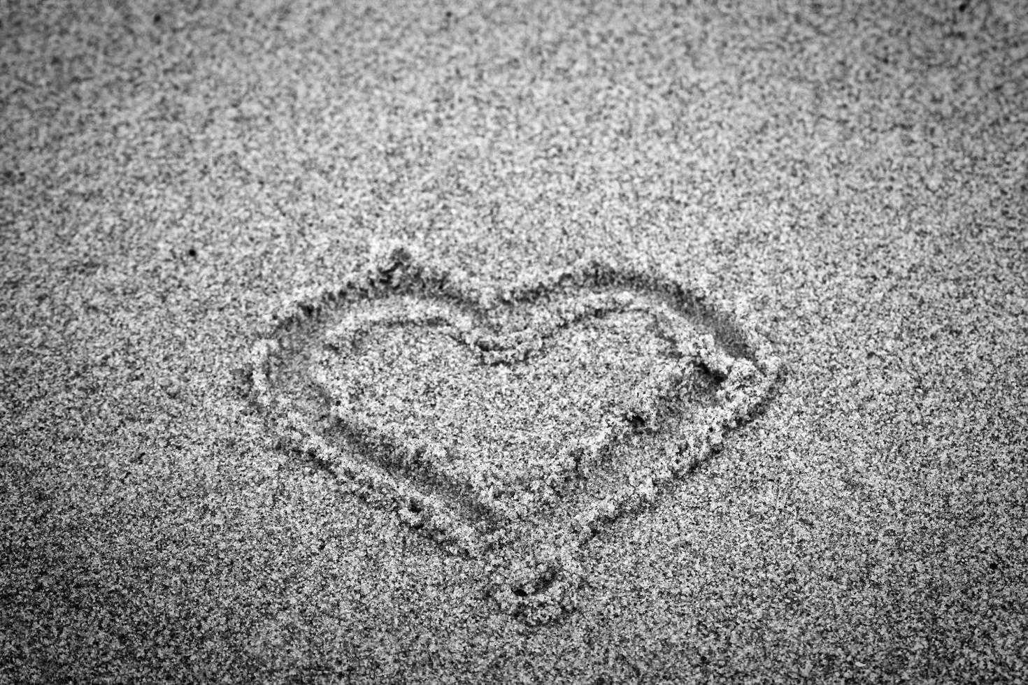 Heart shape on sand. Romantic, black and white photo