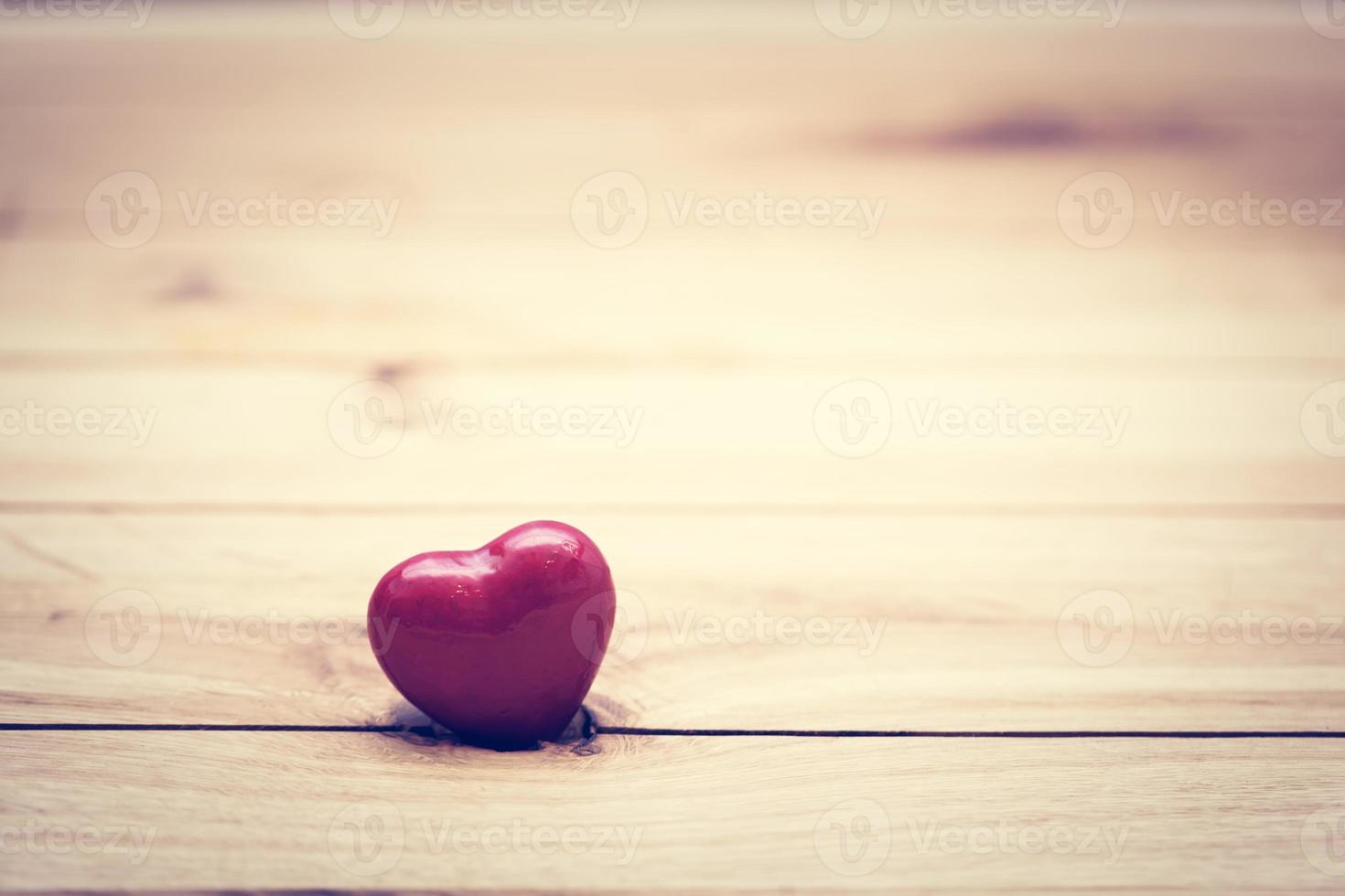 corazoncito rojo sobre madera foto