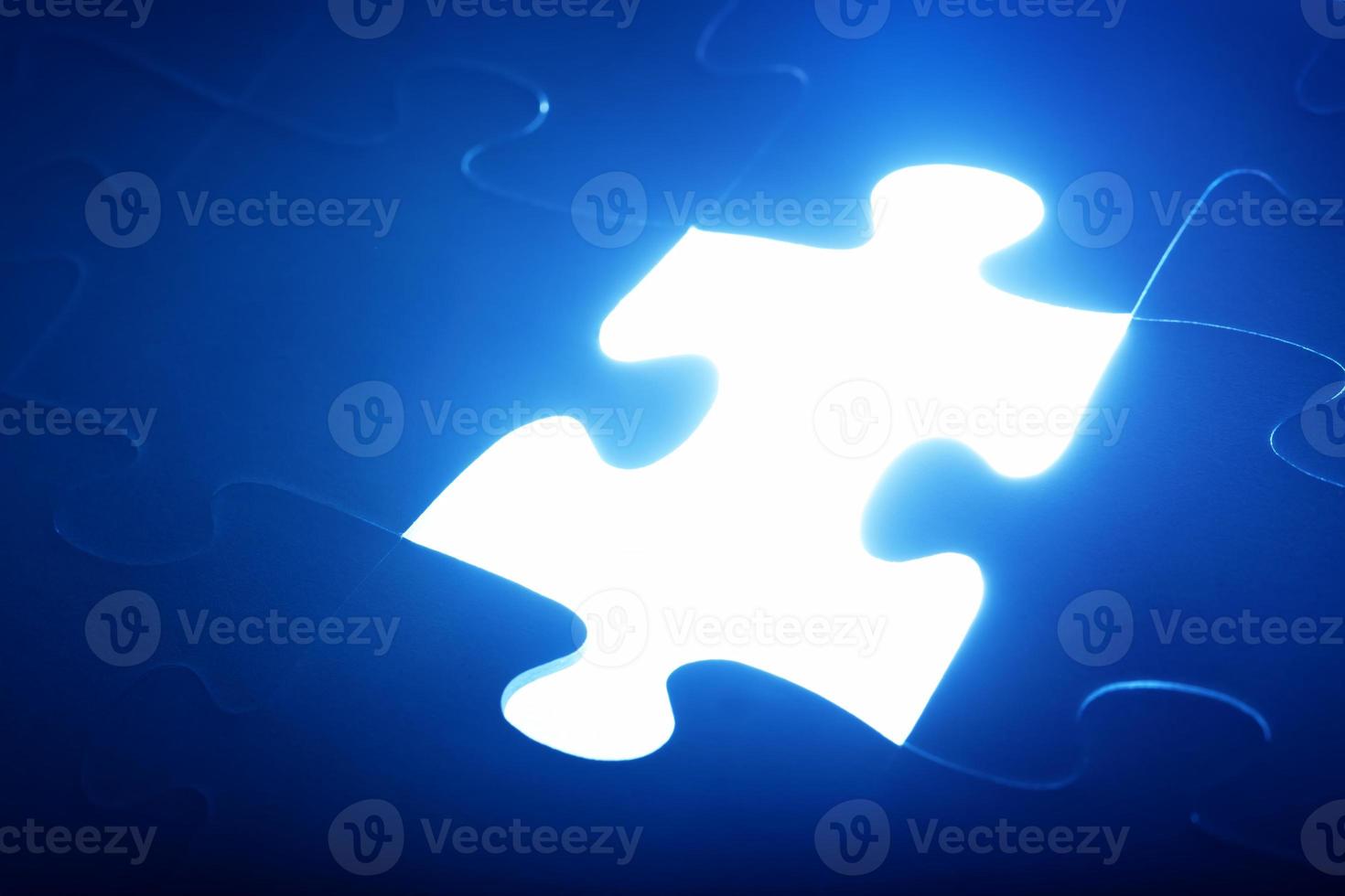 Jigsaw puzzle piece missing. Light glowing. Solution, solve the problem. photo