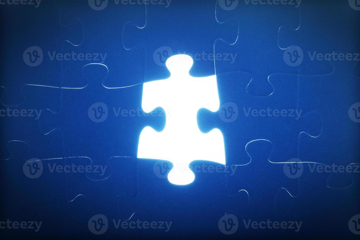 Jigsaw puzzle piece missing. Light glowing. Solution, solve the problem. photo