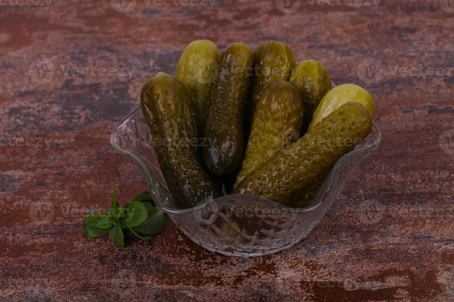 Pickled cucumbers heap in the bowl photo