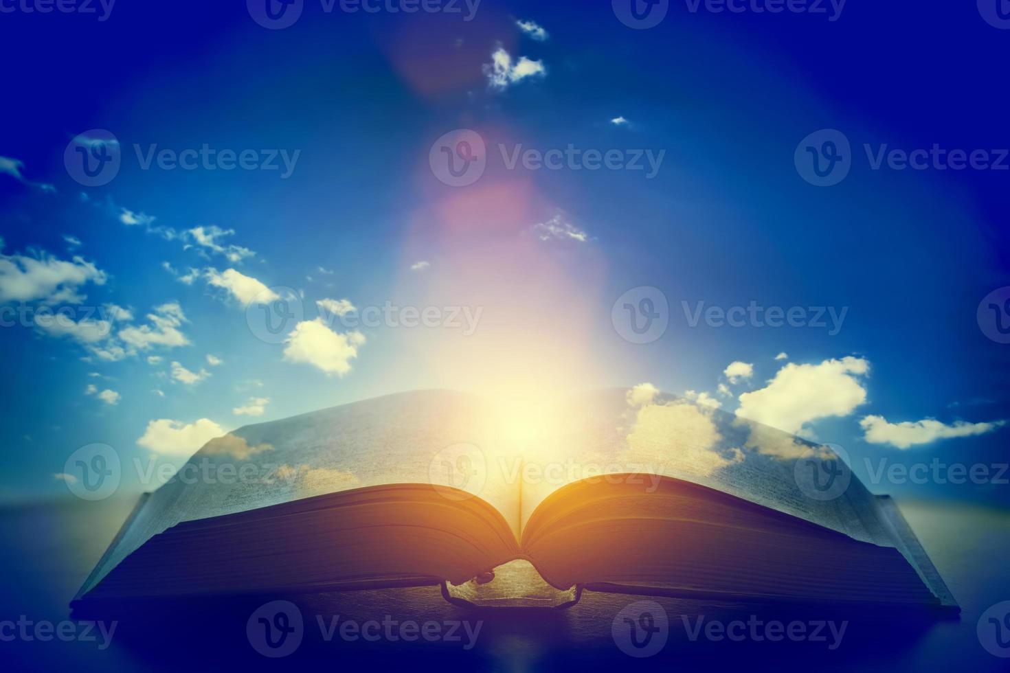 Open old book, light from the sky, heaven. Education, religion concept photo