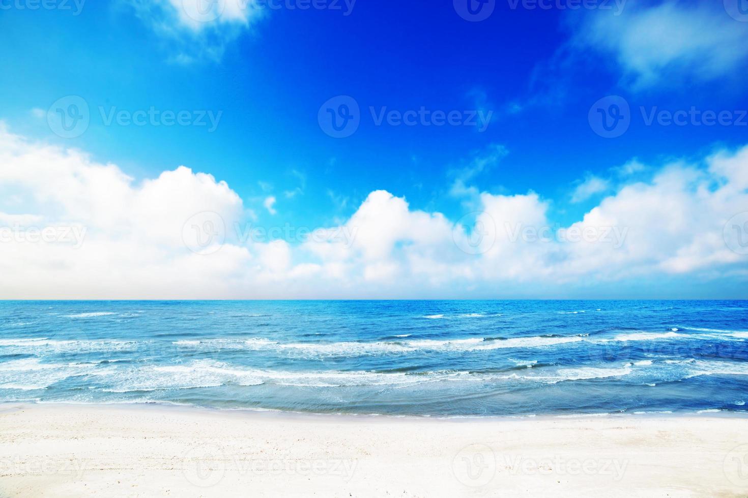 Hot summer beach, sea scenery, blue sunny sky photo