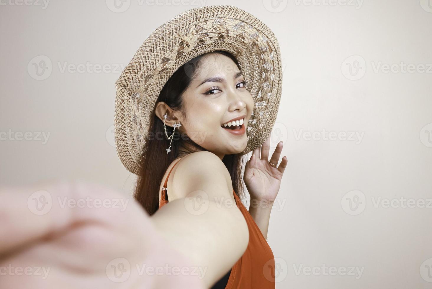 A young beautiful Asian woman taking selfie with holding hand photo