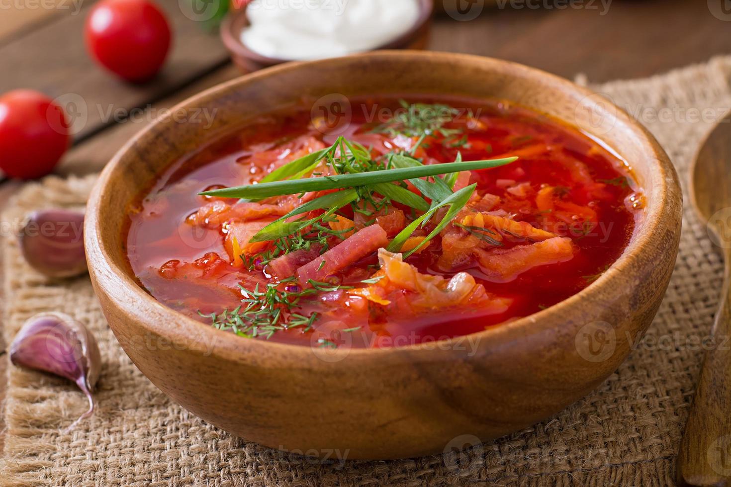 Traditional Ukrainian Russian vegetable borscht on the old wooden background photo