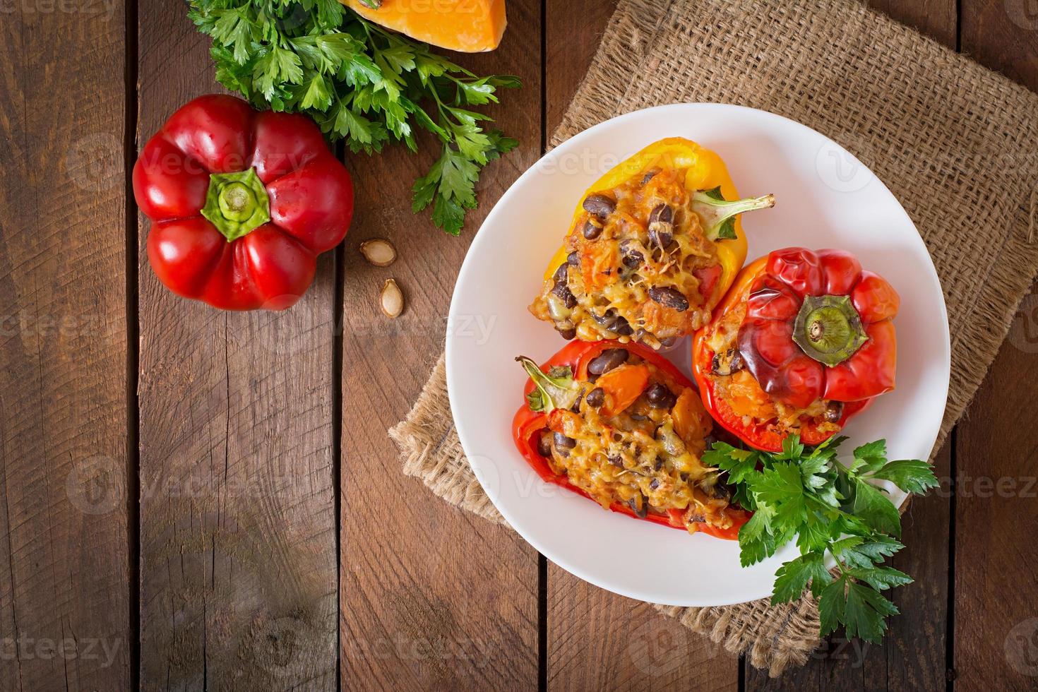 Stuffed peppers with rice, beans and pumpkin in the Mexican style photo