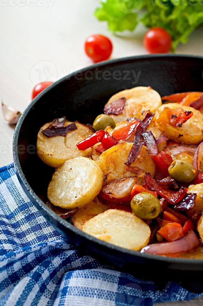 Baked potato with vegetables in a frying pan photo
