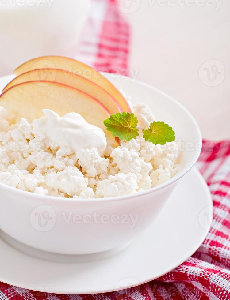 Cottage cheese with apples and sour cream for breakfast close up photo