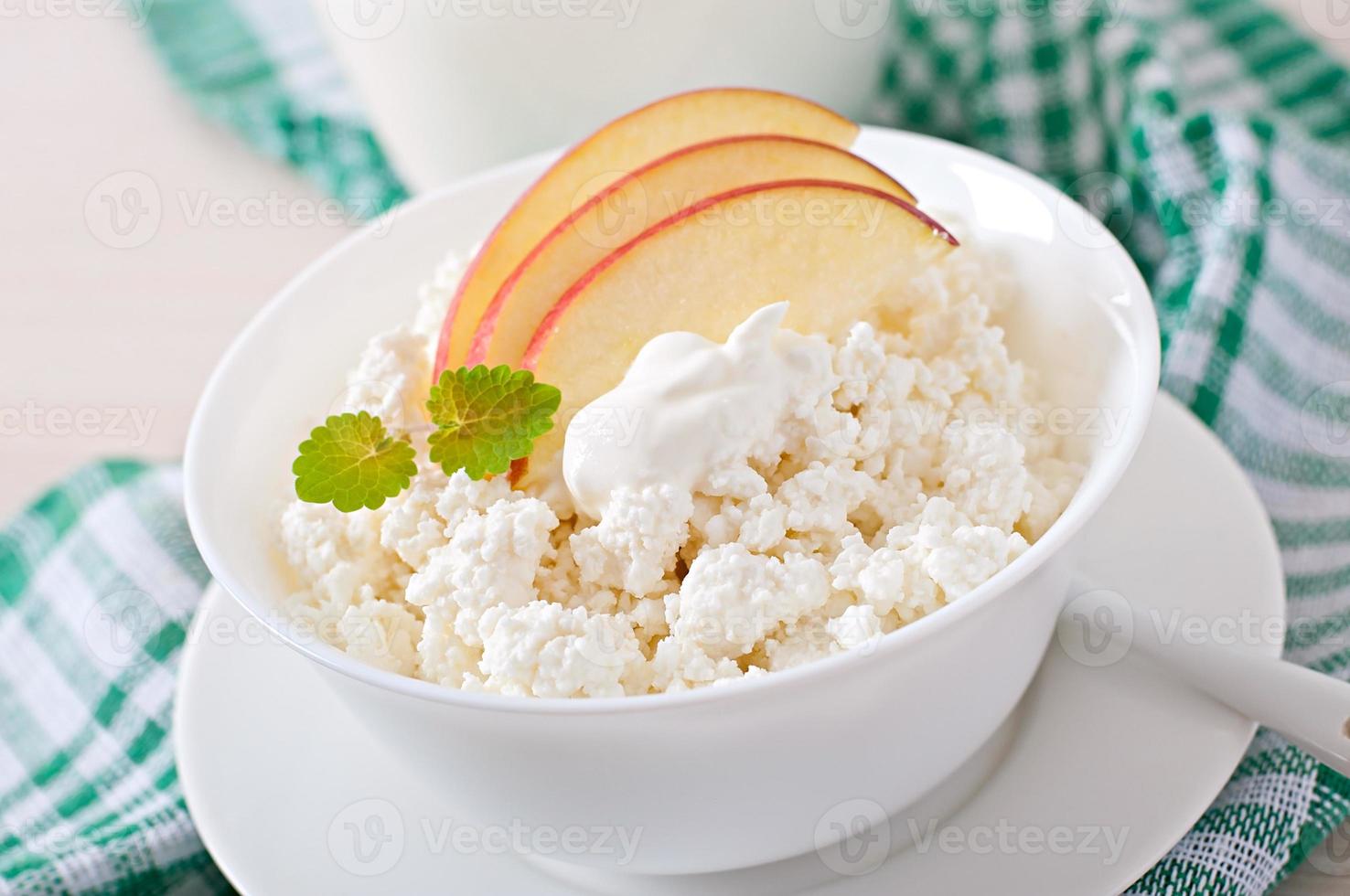 Cottage cheese with apples and sour cream for breakfast close up photo
