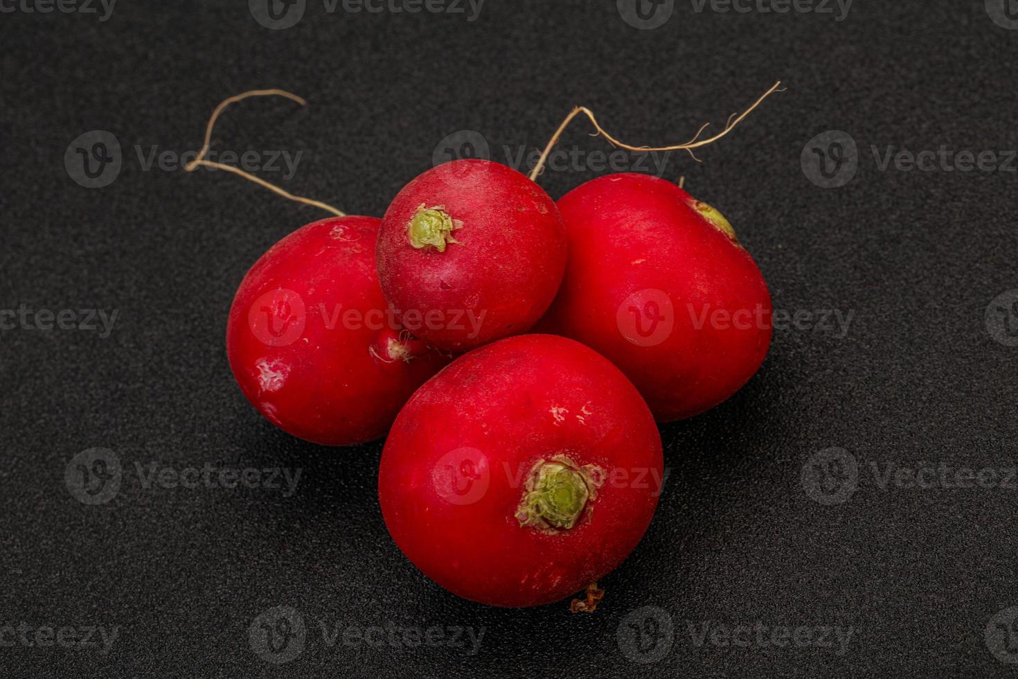 Ripe fresh radish heap over wooden photo