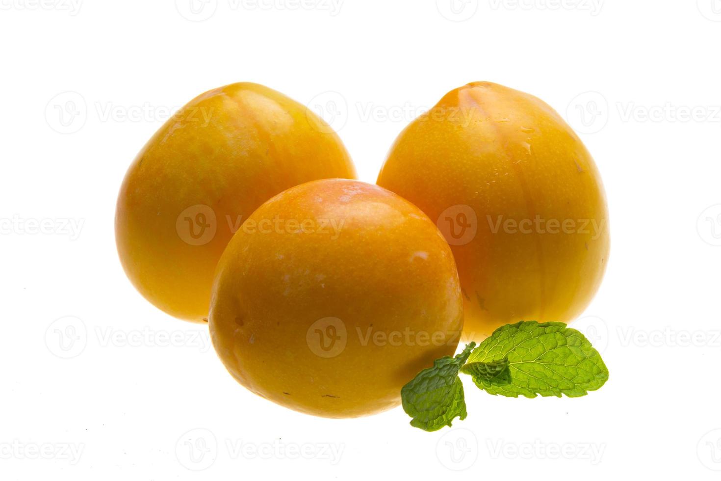 Bright ripe plum with mint photo