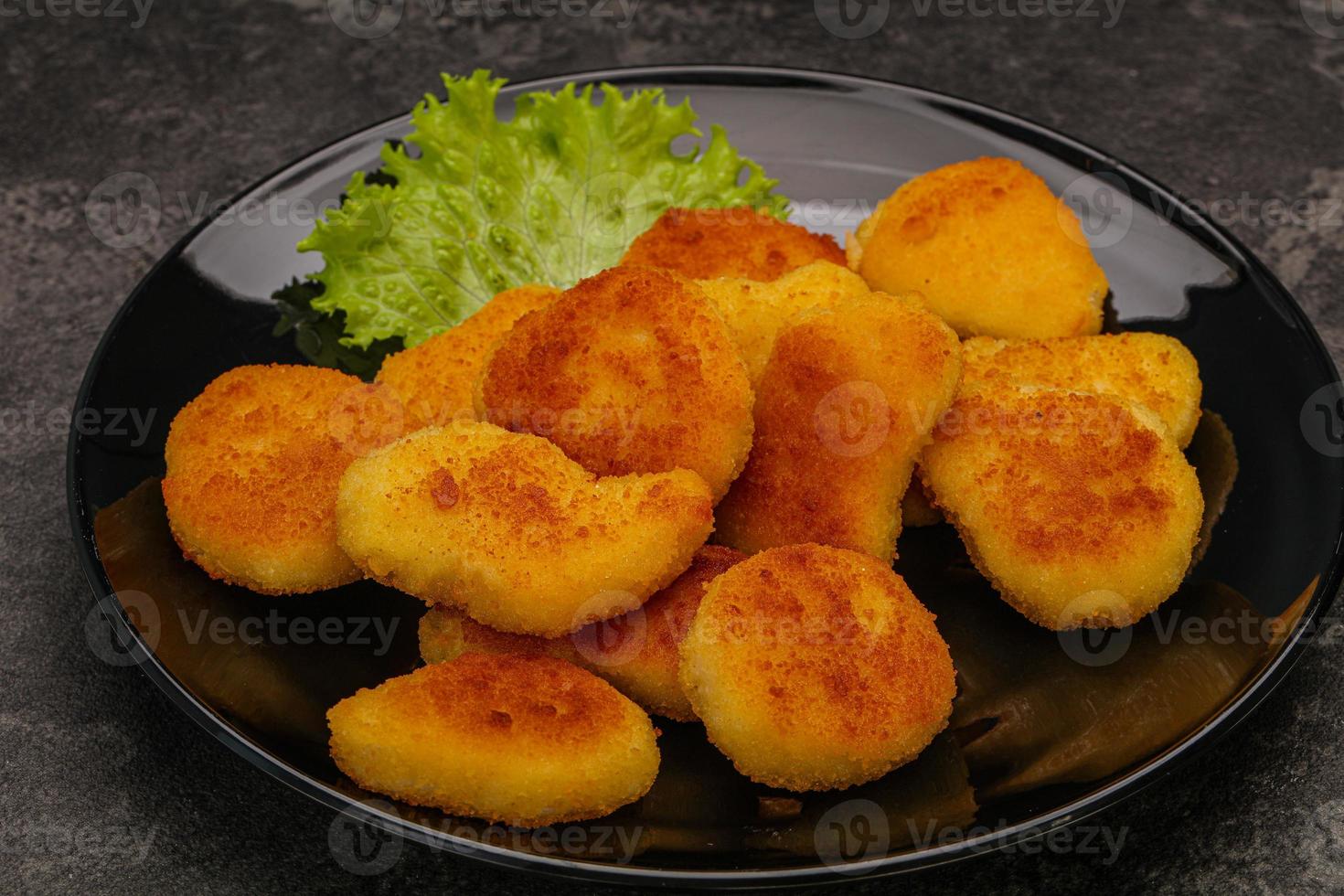 Fried chicken nuggets served salad leaves photo