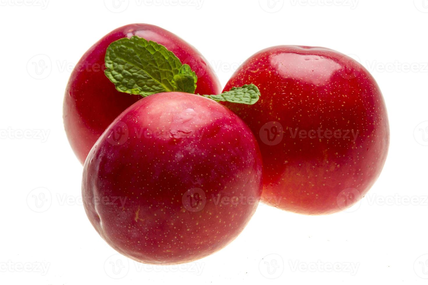 Bright ripe plum with mint photo