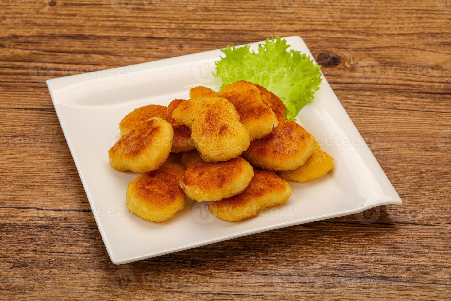 Fried chicken nuggets served salad leaves photo