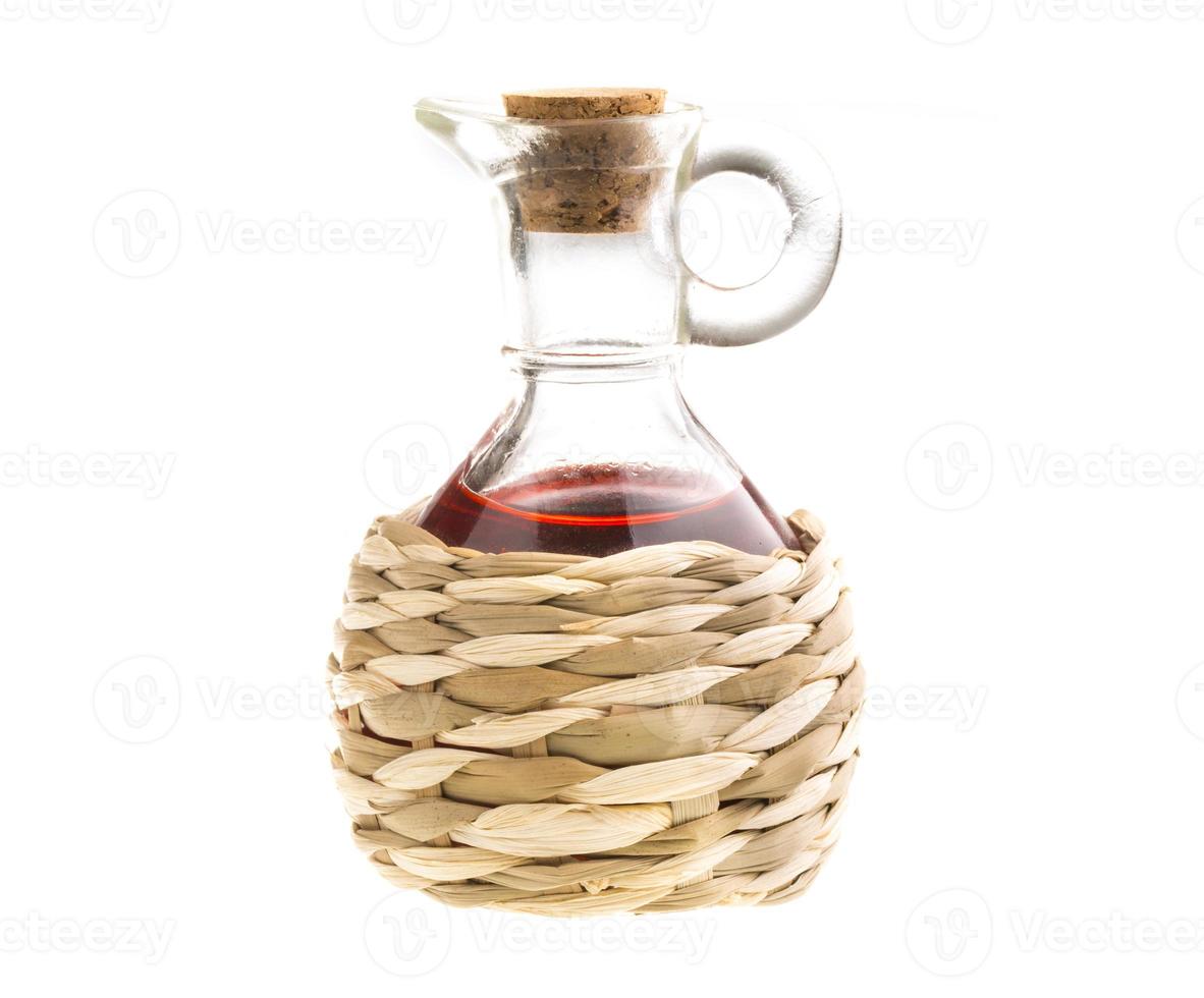 Small decanter with red wine vinegar isolated on the white photo