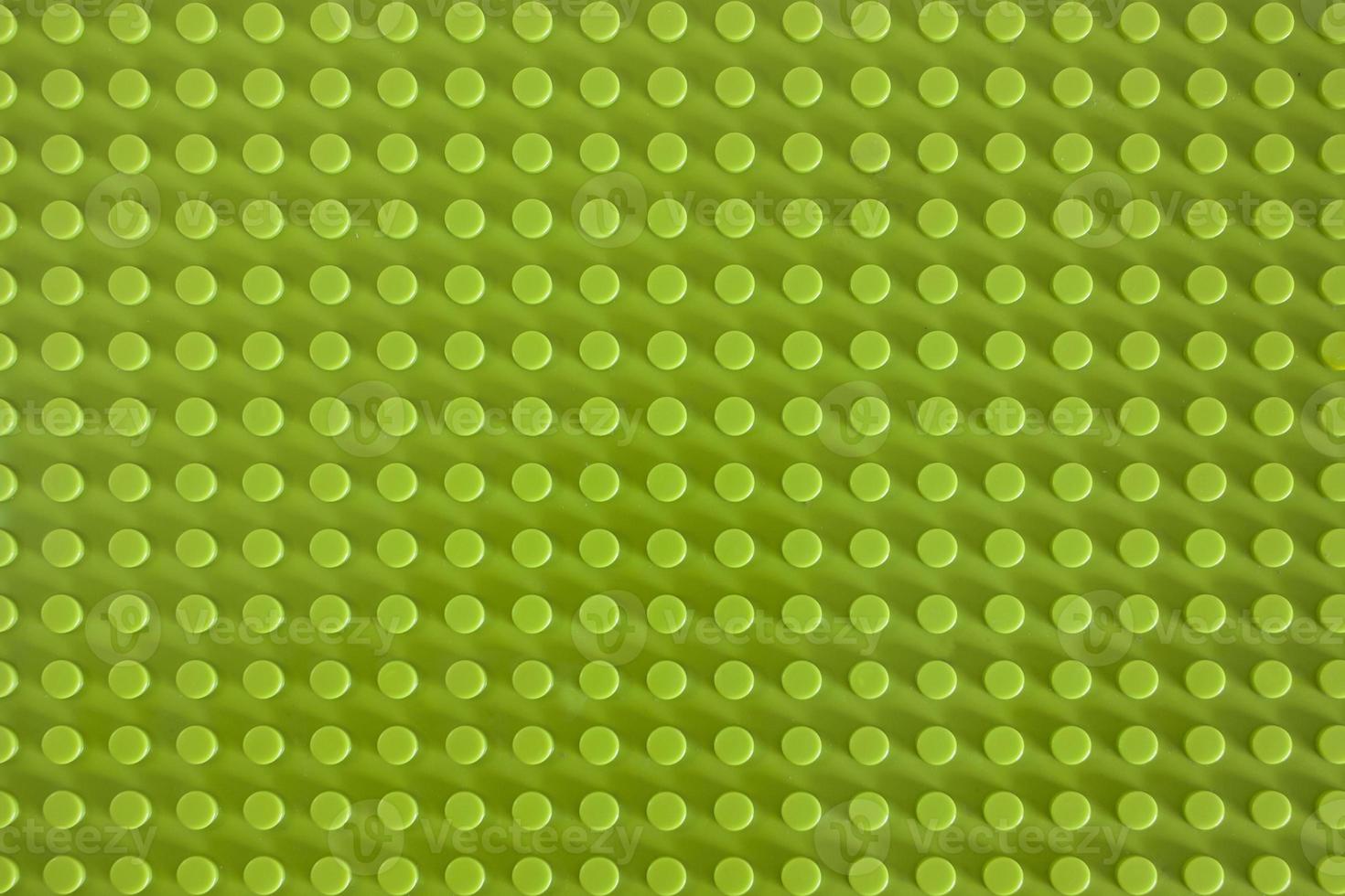 Green plastic building blocks mat with empty copyspace photo
