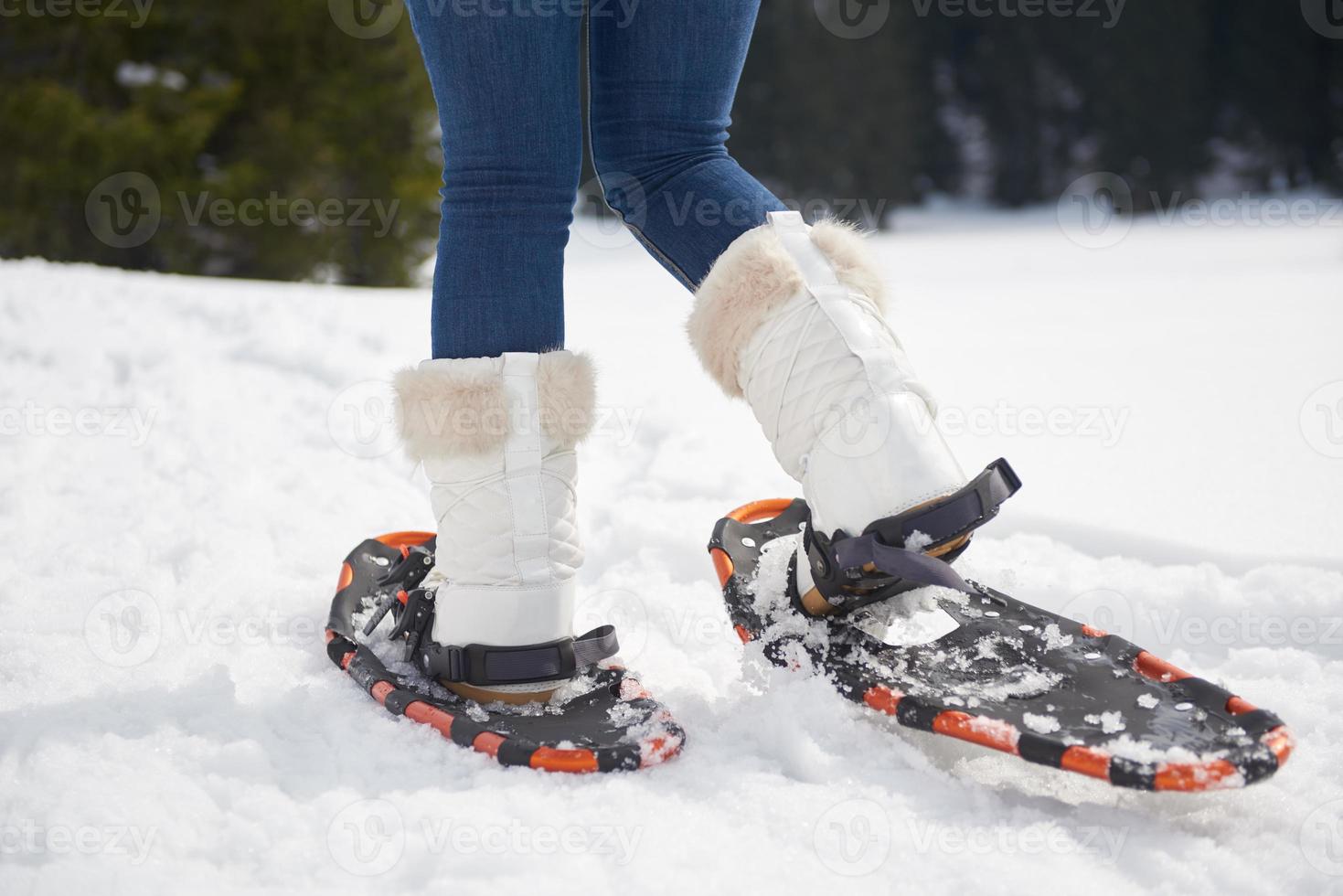 couple having fun and walking in snow shoes photo