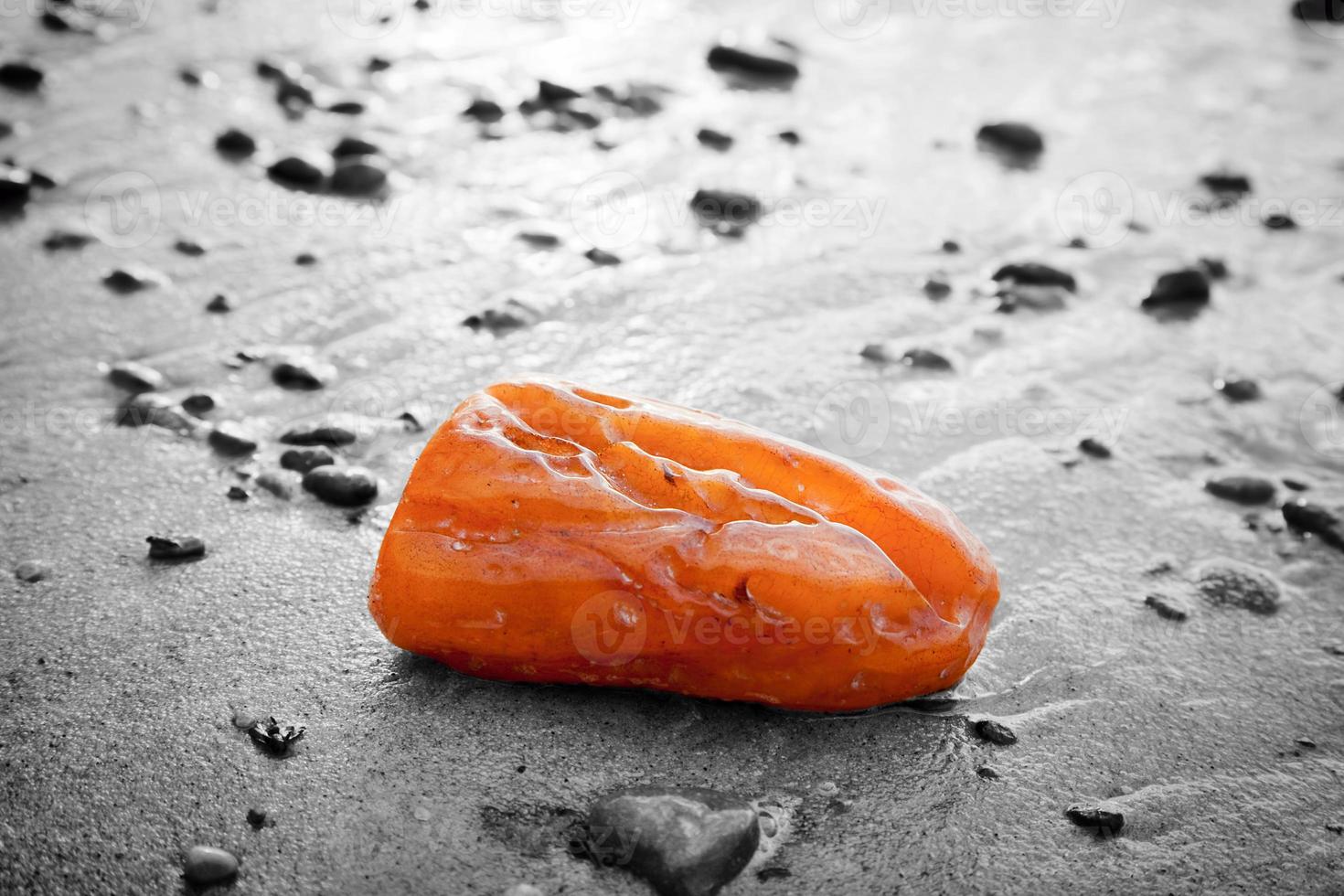 Amber stone on the beach. Precious gem, treasure concept photo