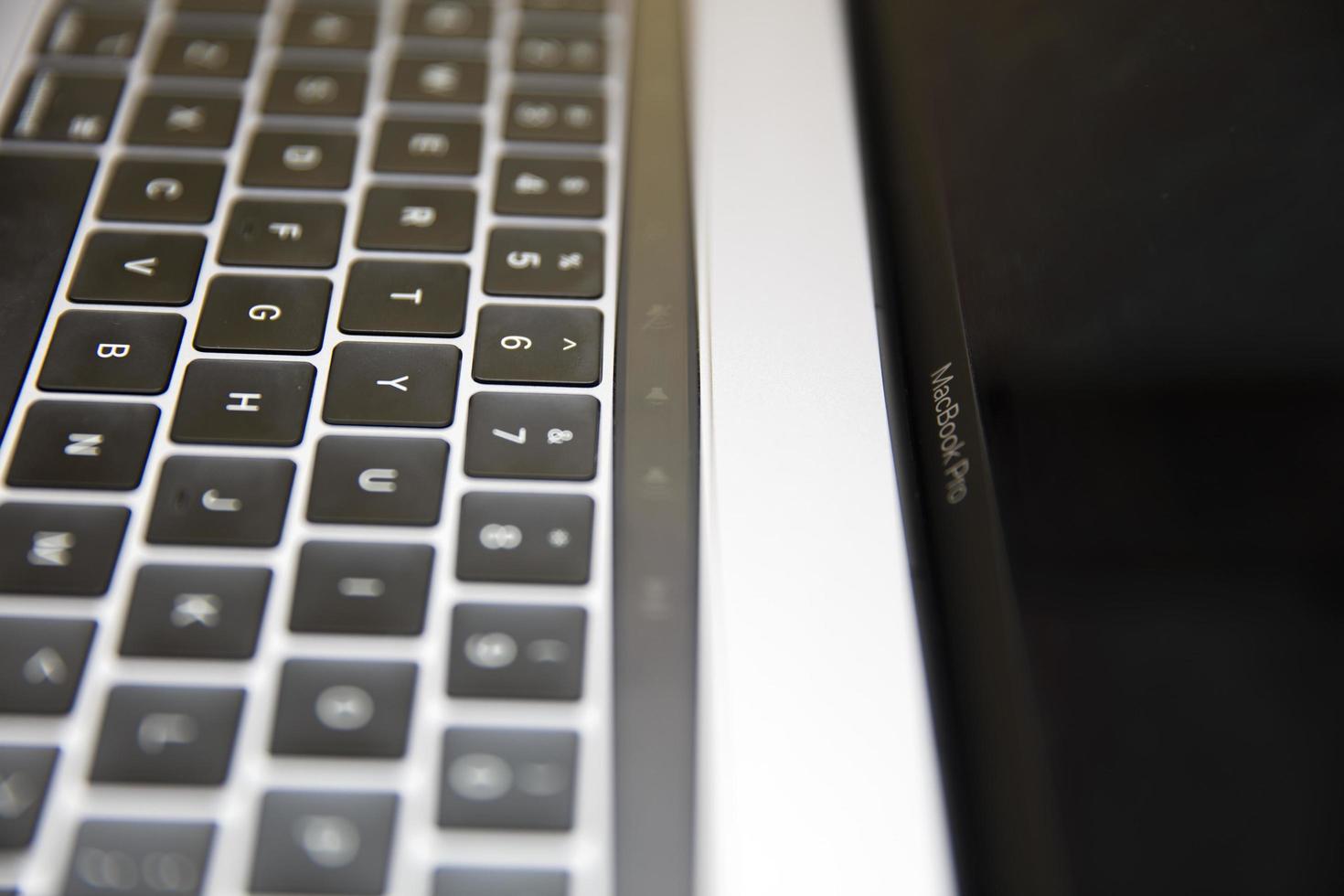 Belgrade, Serbia, 2020 - Detail of MacBook Pro computer isolated on white. The MacBook is a brand of notebook computers manufactured by Apple Inc. photo