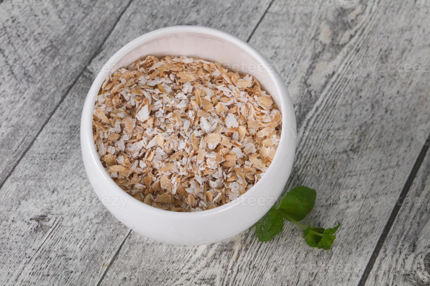 Raw oats in the bowl photo
