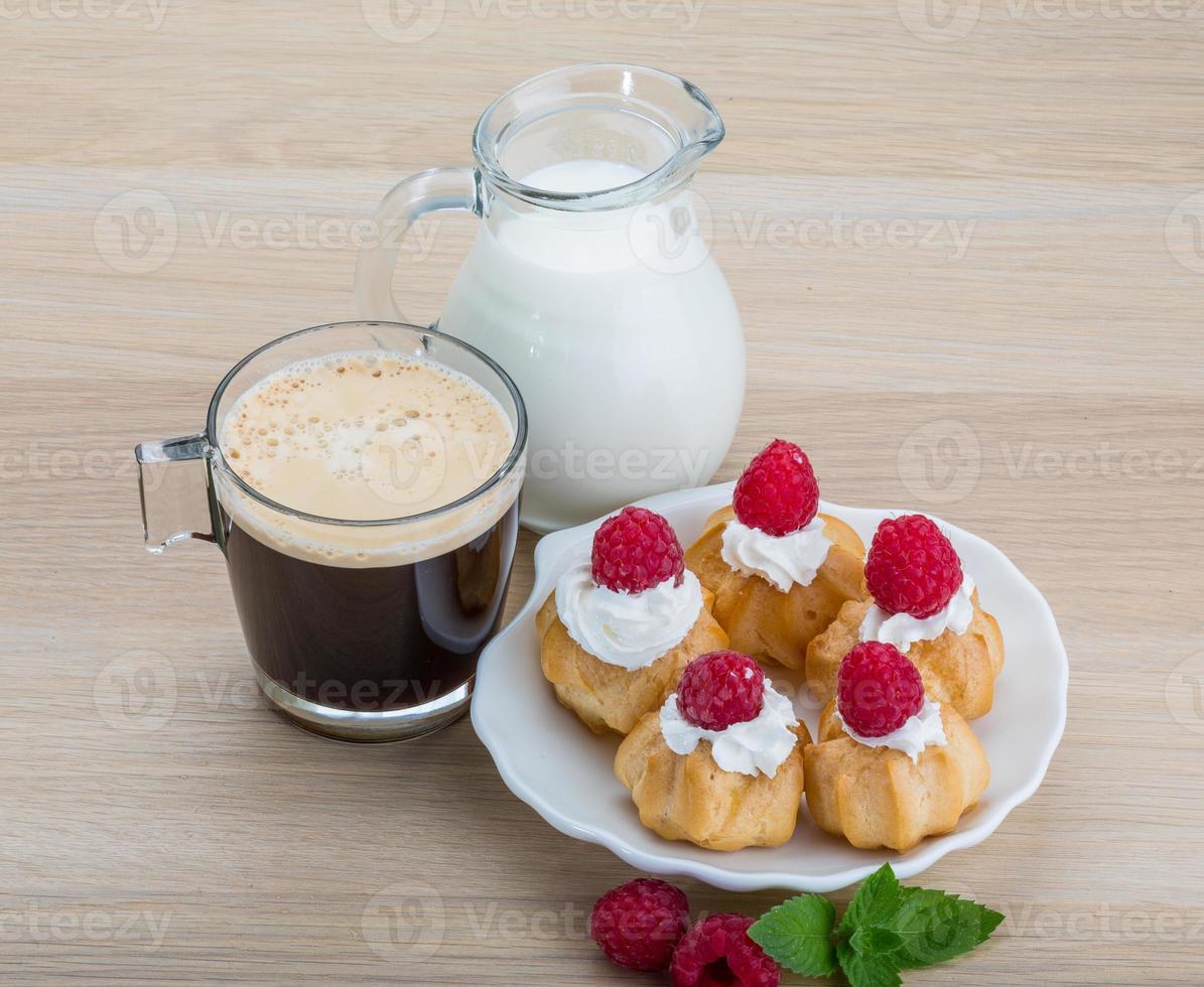 Profiterole with raspberry photo