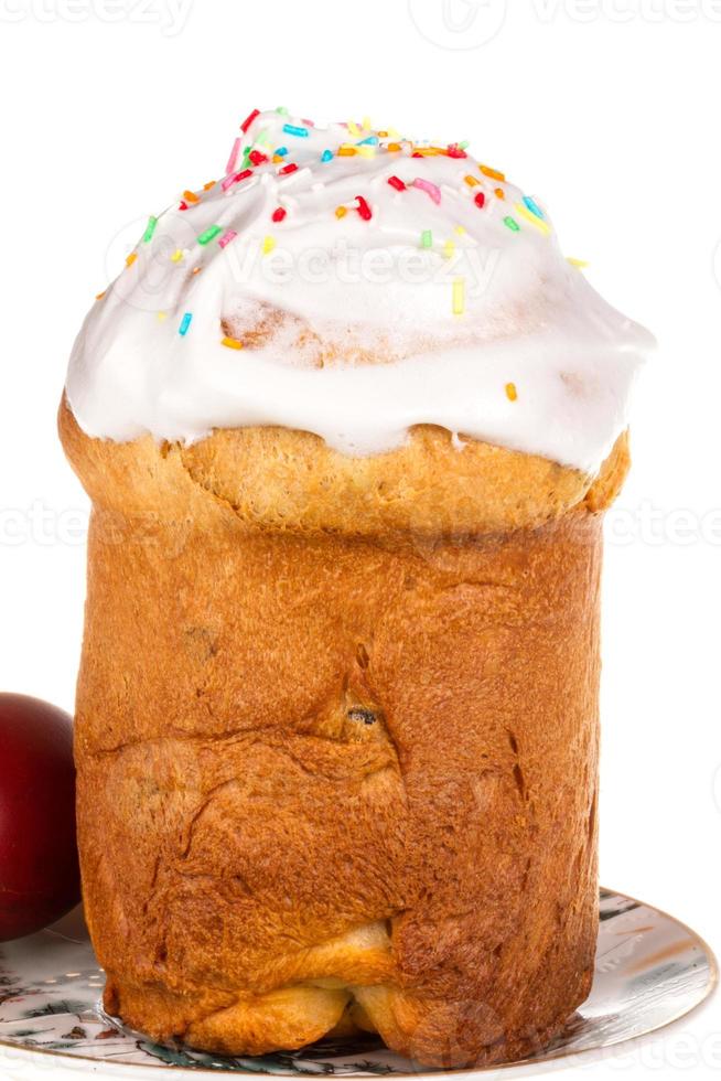 Easter cake with glace icing and easter eggs on white background photo