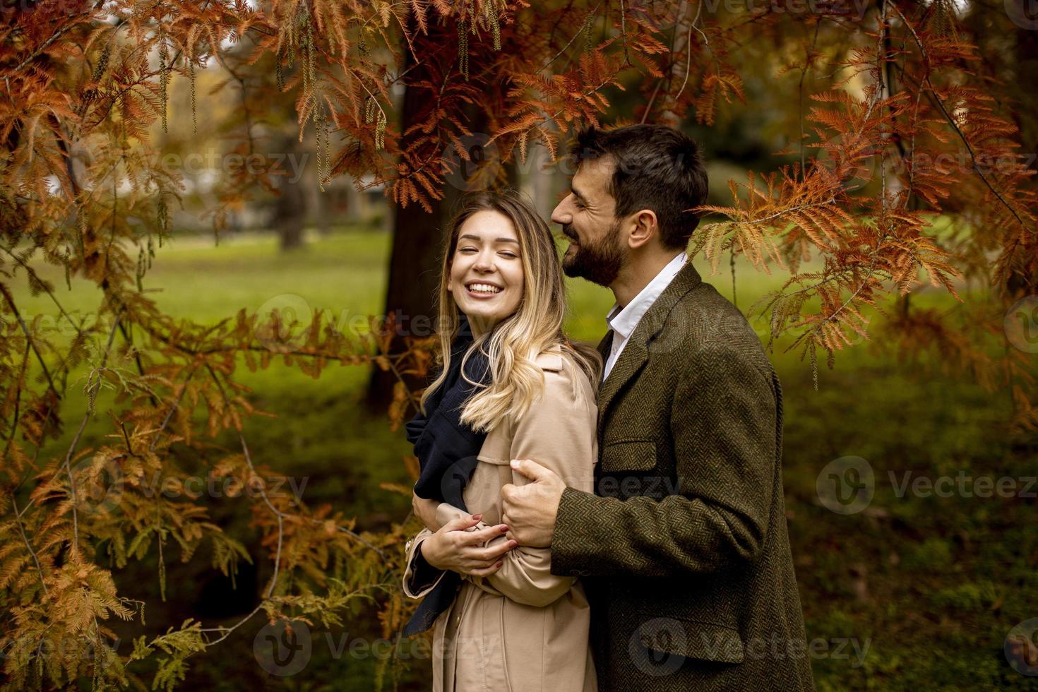 Young couple in the autumn park photo